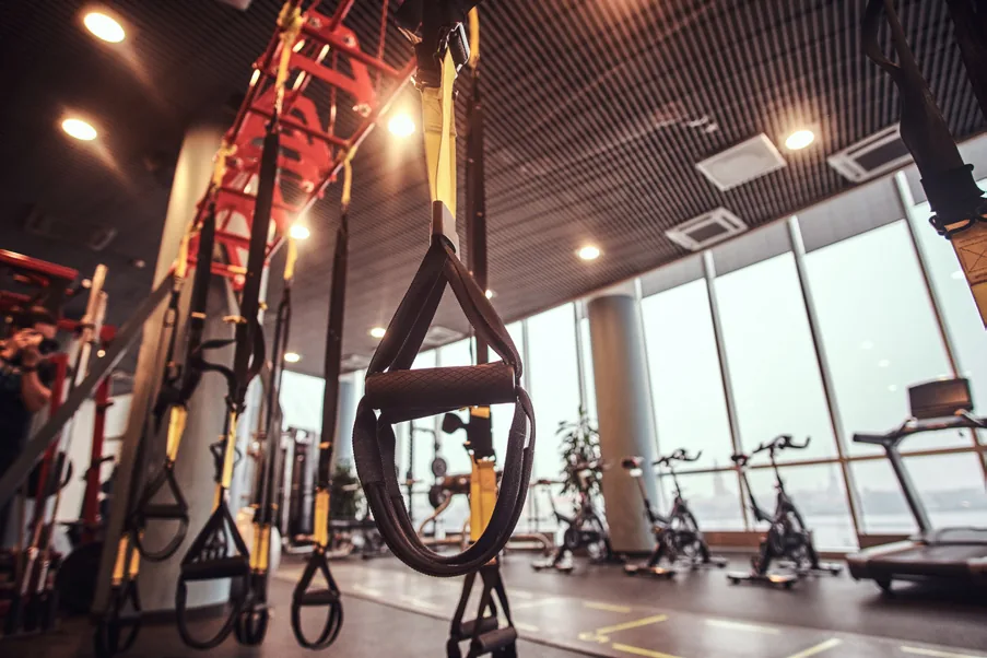 Fitness center with suspension trainers, bikes and large windows
